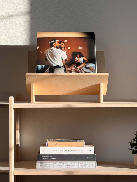 Stylish book and vinyl record holder displaying a photo, showcasing modern design and versatility in home decor.