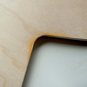 Close-up of blemished furniture showing slight scratch and chip on wood edge, highlighting unique imperfections.
