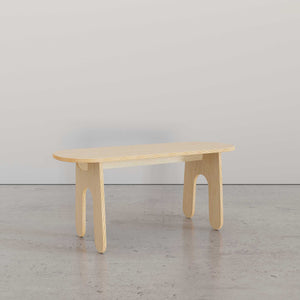 Modern bench in light wood finish with oval top, perfect for versatile seating and modern home decor.