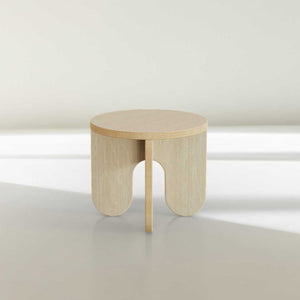 Blemished round wooden side table with unique leg design and subtle imperfections.