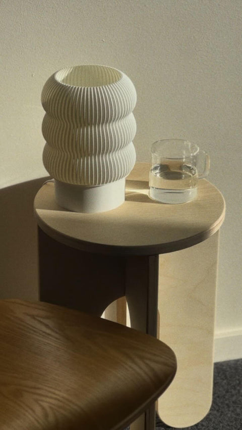 Embrace Midcentury Elegance with a Modern Twist: The Unfnshed Side Table featuring a decorative vase and glass.