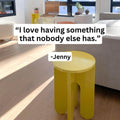 Unfnshed yellow side table in modern living room with quote "I love having something that nobody else has." by Jenny.