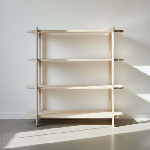 Four level wooden bookshelf against a white wall with sunlight casting shadows on the floor.