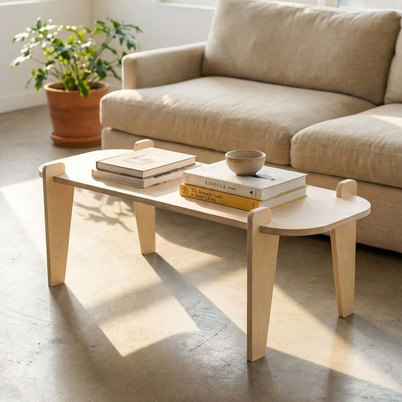 Beige sofa and coffee table in a bright room with large windows