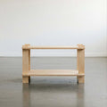 Minimalist wooden table with open shelving, perfect for modern home decor.
