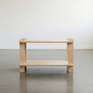 Minimalist wooden table with open shelving, perfect for modern home decor.