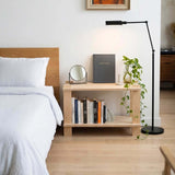 Modular Shelf next to a bed with books, a mirror, and a plant, perfect for home or office use.