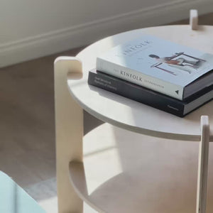 Round coffee table showcasing books, perfect for storage and enhancing your living room decor.