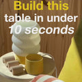 Unfinished side table with decorative objects, highlighting easy assembly in under 10 seconds.