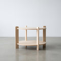 Wooden side table with two shelves on a plain background
