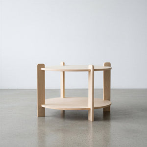 Wooden side table with two shelves on a plain background