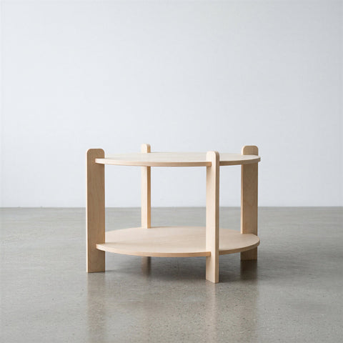 Wooden side table with two shelves on a plain background