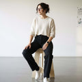 Woman sitting on stool