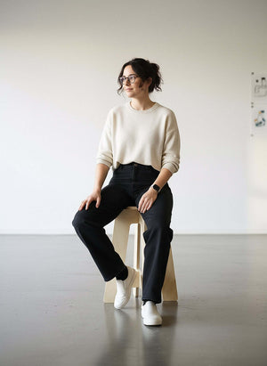 Woman sitting on stool